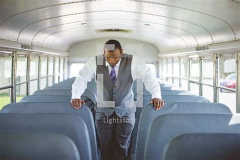 A Pastor Praying On A Church Bus — Photo — Lightstock