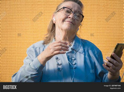 Portrait Of Old Lady Grandmother Makes Selfie Outdoors At Sun Day Modern Caucasian Granny
