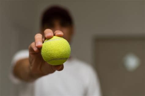 Premium Photo Close Up Of Male Hand Holding Tennis Ball And Racket T