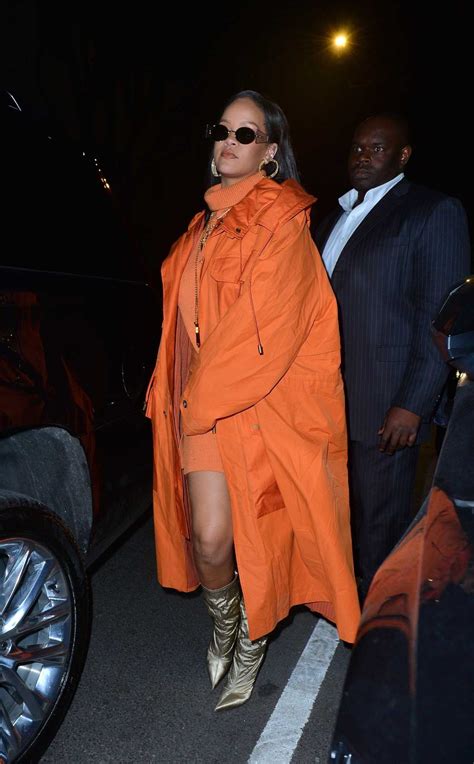 rihanna in an orange trench coat arrives at bergdorf goodman for her fenty launch in new york 02