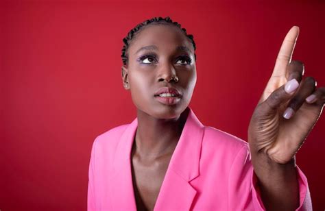 Premium Photo Stylish Black Woman Wearing Pink Blazer Pointing Away With Finger