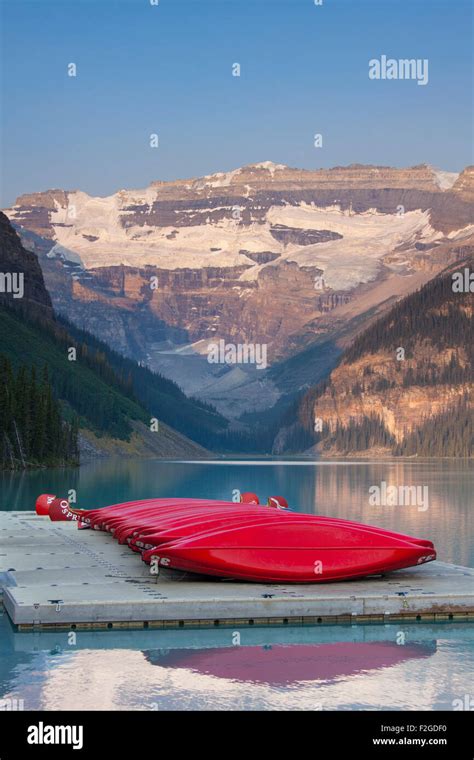 Red Canoes At Glacial Lake Louise With Victoria Glacier Banff National