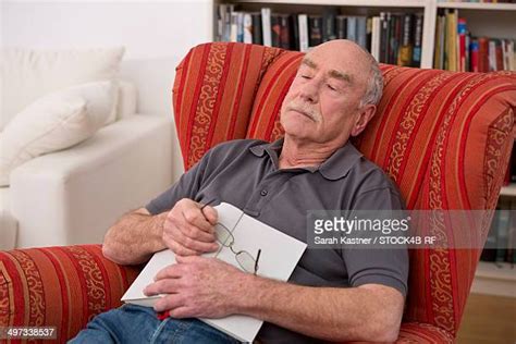 Tired Old Man Sitting In An Armchair Photos And Premium High Res