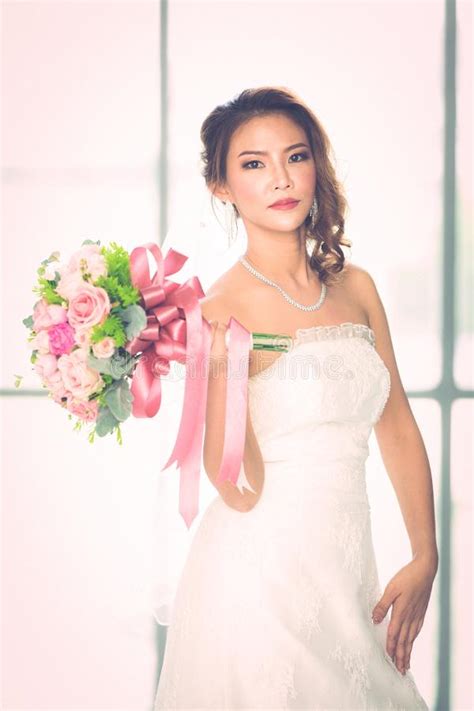 Asian Bride Standing And Holding A Bouquet Stock Photo Image Of