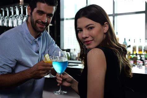 Couple Of Handsome Man And Beautiful Woman Drinking Cocktails In Luxury