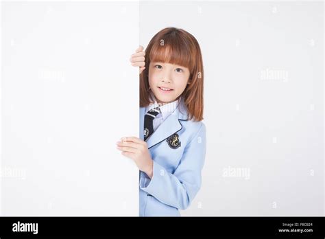 Elementary School Age Girl With Short Hair In School Uniforms Behind A