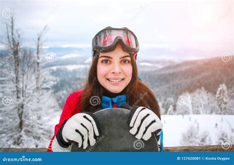 Portrait Happy Girl With Snowboard On Top Of Snowy Mountain Stock Image