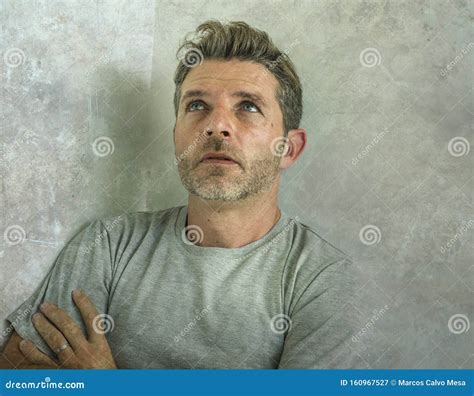 Dramatic Portrait Of Middle Aged Sad And Depressed Man In Pain Feeling