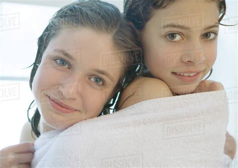 Two Preteen Girls Sharing Towel Stock Photo Dissolve