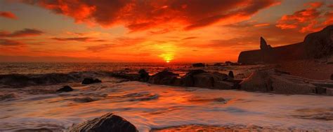 Download Wallpaper 2560x1024 Sea Waves Rocks Beach Sunrise Dual