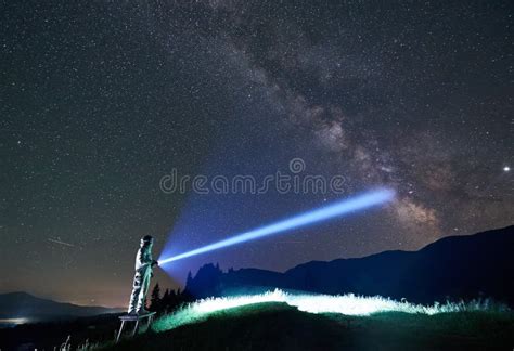 Space Traveler Shining Flashlight Into Majestic Night Sky Stock Image