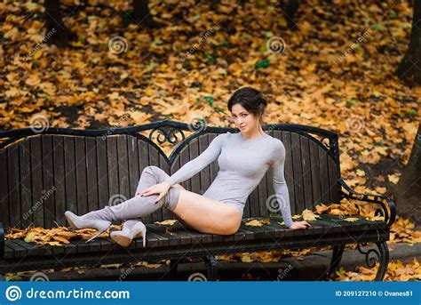 Brunette Female In Autumn Forest Public Park Sport Slender Body Stock
