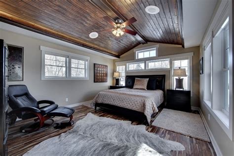 Your first impulse might be to think of the sloped ceiling and small space of an attic bedroom as a minus, but instead, embrace its benefits. Master Bedroom with Vaulted Wood Ceiling - Traditional ...