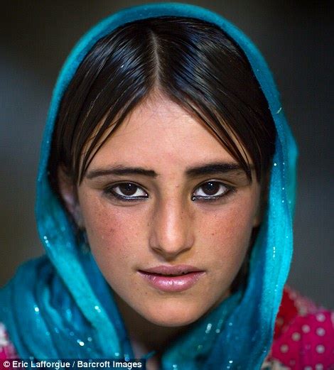 Portrait Of An Afghan Girl With Kohled Eyes Wearing A Vibrant Blue