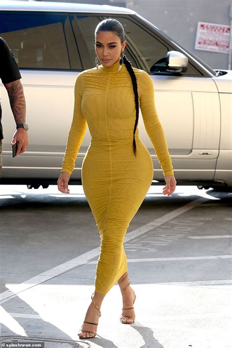Kim Kardashian Puts Her Curves On Display In Very Tight Yellow Dress
