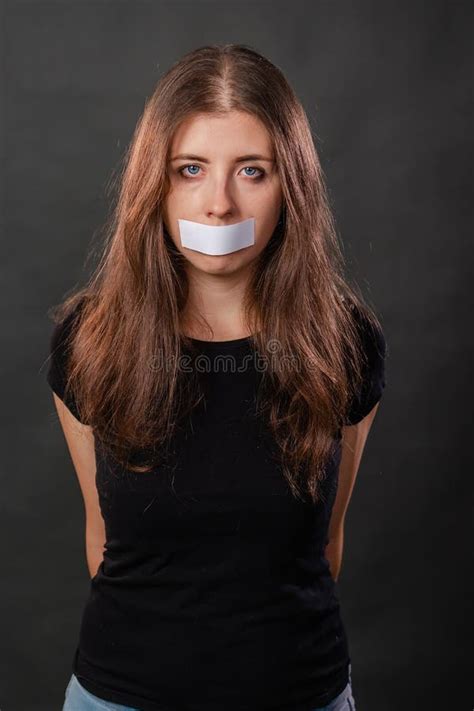 Portrait Of A Young Woman With Duct Tape Sealed In Her Mouth