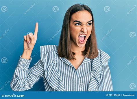 Young Brunette Student Girl Pointing Up With Finger Angry And Mad