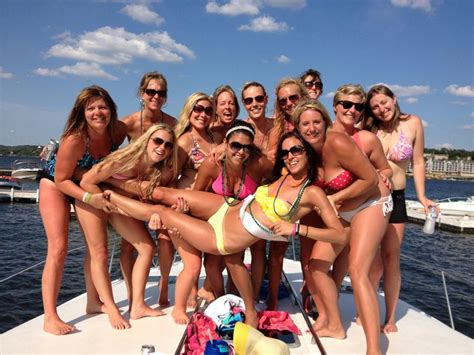 A Group Of Women In Bikinis On A Boat Posing For A Photo With One Another