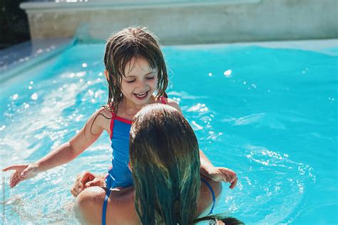 Cute Girl Swimming With Her Mom In Pool In Summer By Stocksy Contributor Aila Images Stocksy