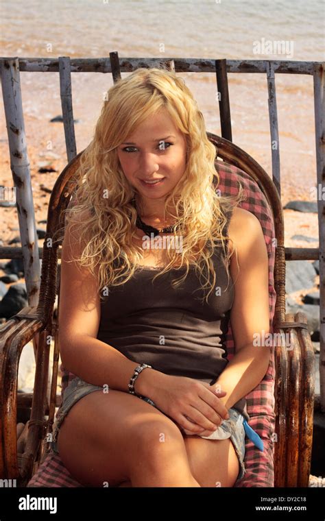 Attractive Young Blond Girl Reclining On A Beach Chair Goa India