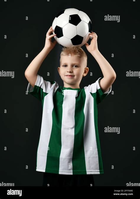Blond Smiling Boy Child In Sports Green And White Clothes Standing