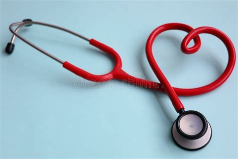 Red Stethoscope With Heart On Blue Modern Background Stock Photo
