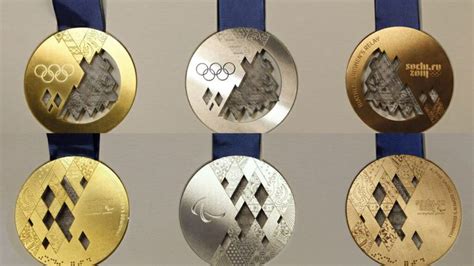Four Olympic Medals Are Shown In Three Different Colors