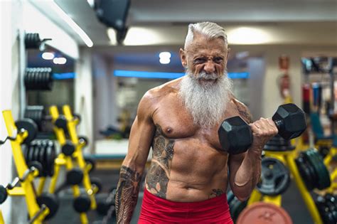 Senior Fitness Man Doing Biceps Curl Exercises Inside Gym Fit Mature