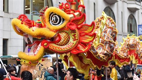 As soon as the clock strikes 11:59 the times square ball descends. 'Biggest Chinese New Year celebration outside Asia' held ...