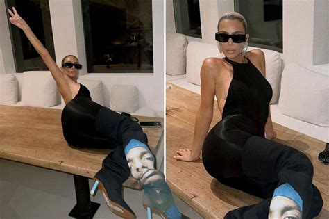 kim kardashian puts her butt on full display as she lays out on her dining table in 2 5k boots