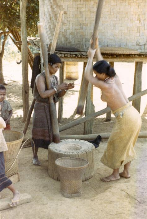 Two Nyaheun Women Are Pounding Rice In A Village In Attapu Province UWDC UW Madison Libraries