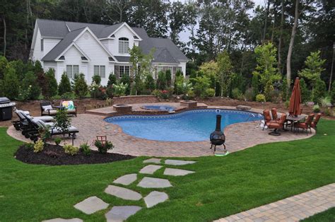 Landscaped Backyard Design With Free Form Vinyl Pool Spillover Spa
