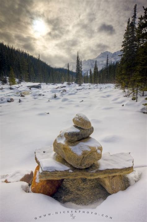Photo Of A Stone Cairn Set In The Beautiful Winter Scenery Of The Rocky