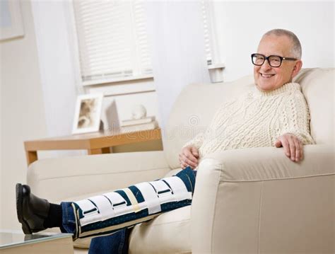 Disabled Man With Leg Brace Sitting On Sofa Stock Photo Image Of
