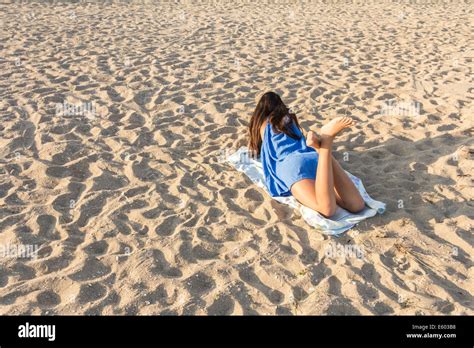 Rear View Of Pretty Girl Lying On Sandy Beach On Hot Summer Stock Photo Alamy