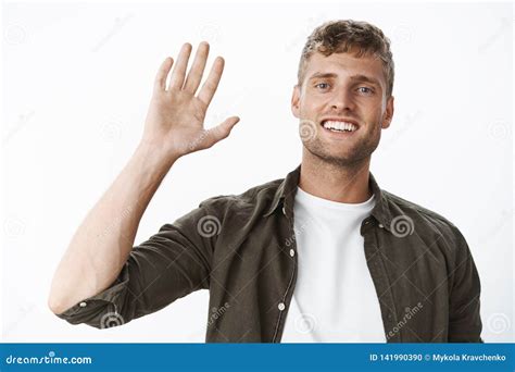 Friendly Blond Guy Saying Hello Waving Friendly At Camera Greeting