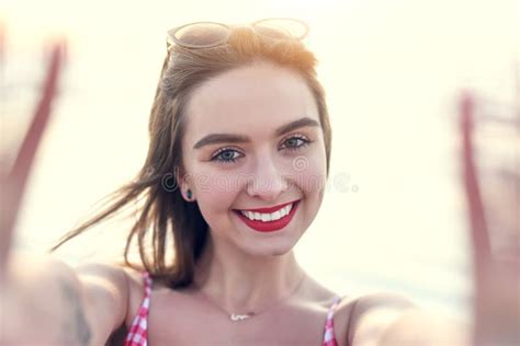 Taking A Selfie By The Sea Is A Must Portrait Of A Beautiful Young Woman Taking A Selfie At The