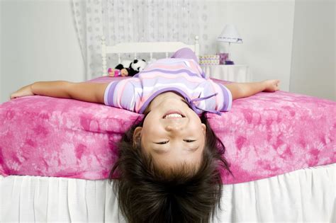 Girl Lying On Bed With Head Hanging Off Edge Free Photo Download