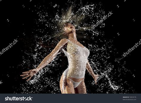 Girl In A Spray Of Water On A Black Background Stock Photo 72818179