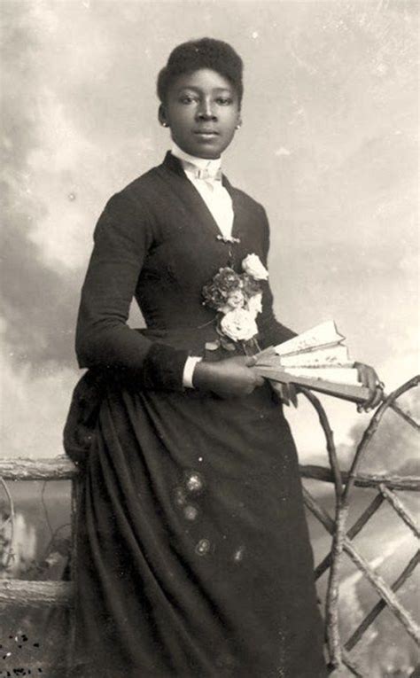 An Old Black And White Photo Of A Woman Holding Flowers