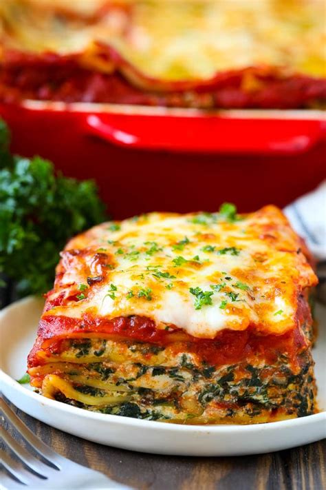 A Piece Of Spinach Lasagna On A Plate Garnished With Chopped Parsley Vegetarian Lasagna