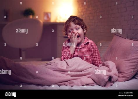 Adorable Laughing Baby Boy In Bed Before Going To Sleep Stock Photo Alamy