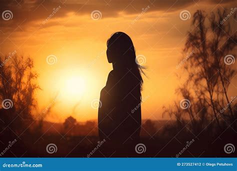 A Woman Standing In Front Of A Sunset With Her Hair Blowing In The Wind And The Sun Setting