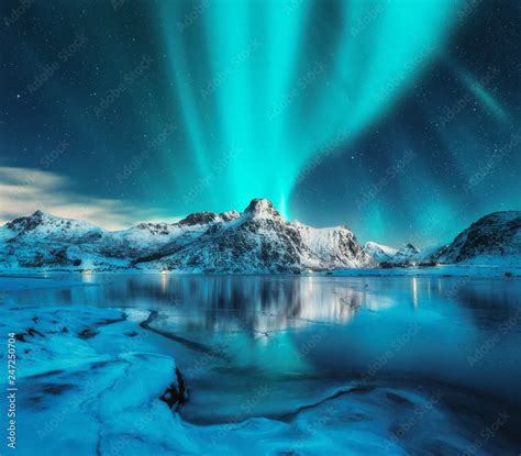 Aurora Borealis Over Snowy Mountains Frozen Sea Coast Reflection In