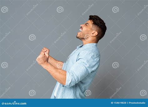 Guy With Clenched Fists Screaming Or Roaring Loudly Side View Stock