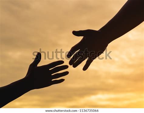 Closeup Helping Hands On Sunset Sky Stock Photo Edit Now 1136735066