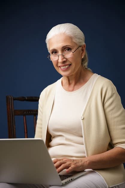 Free Photo Cheerful Old Woman Using Laptop Computer