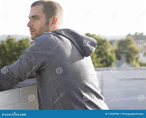 Thoughtful Man Leaning On Wall Looking Away Royalty Free Stock Photos