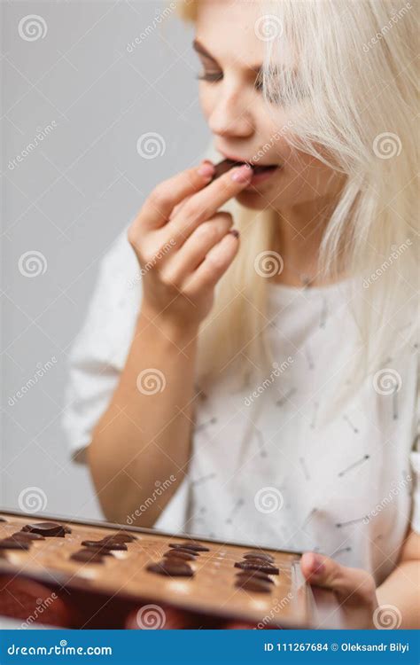 Beautiful Blond Girl Eating Chocolate Candies Stock Photo Image Of