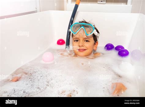 Cute Boy Lay Calmly In The Bathtub Wear Snorkeling Mask And Scuba